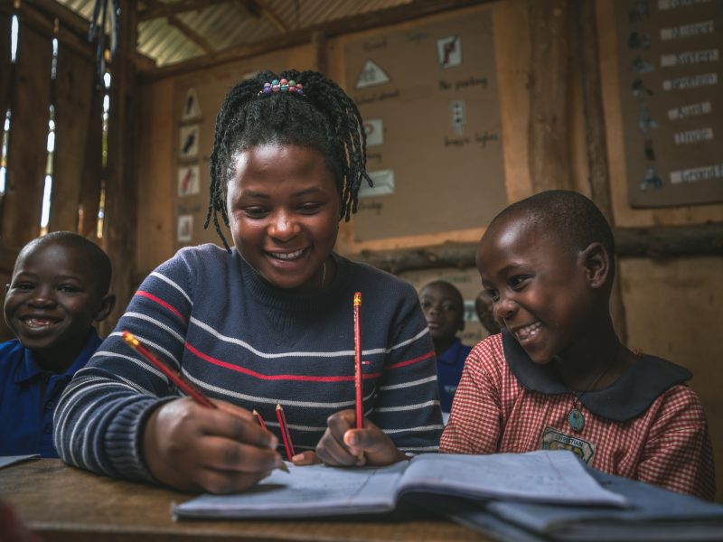 College girl teaching happy student